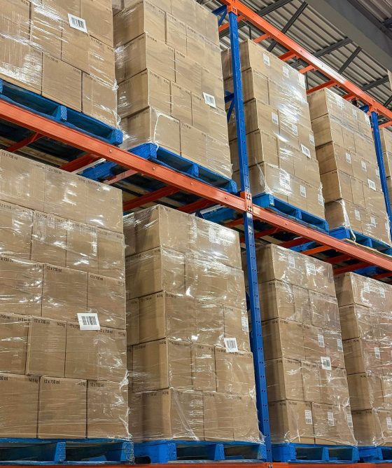Pallets of boxes of wine stacked in distribution centre ready for shipment.